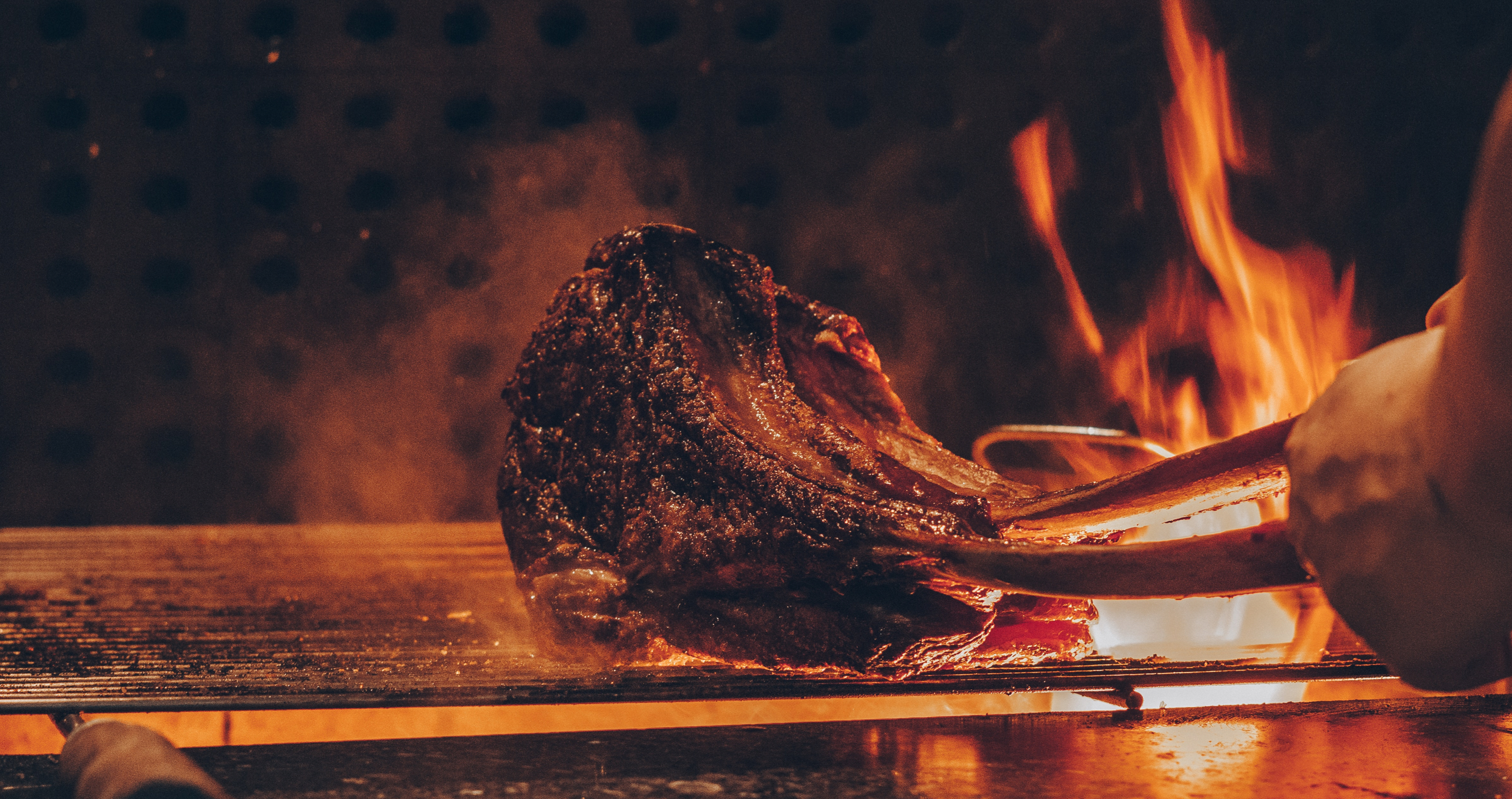 Steak being cooked on open fire